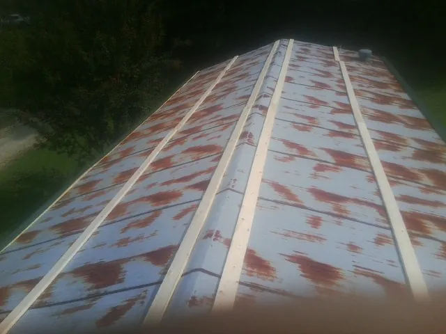 Rusted metal roof panels with new wood purlins before replacement — Storm Damage Roof Repair in Page by Roofing Brothers